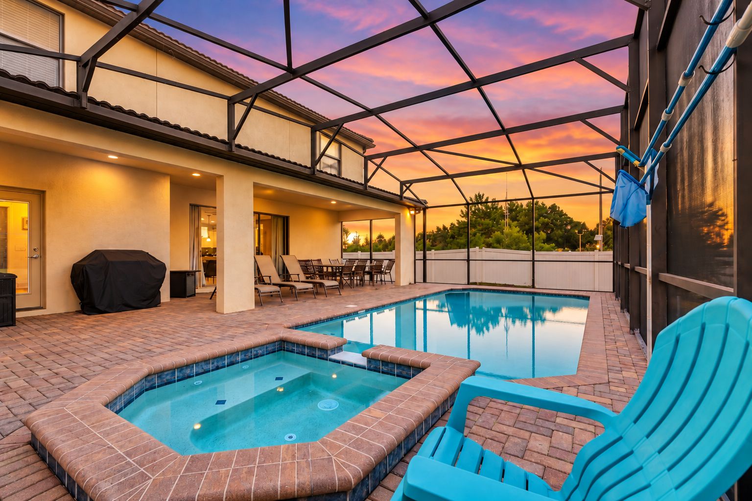 A swimming pool with a hot tub, outdoor seating, and a covered patio area.