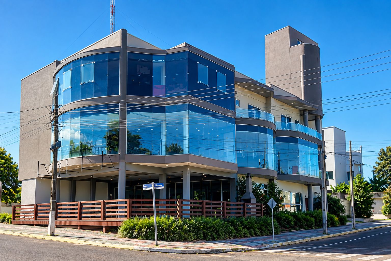 A modern multi-story building with large glass windows and a flat roof.