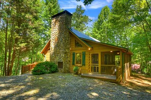 A cabin with a stone chimney, wooden exterior, and a porch. - Chestnut Bearcation - Pet-Friendly, Screened Porch, Game Room, Wood-Burning Fireplace & More! (Blue Ridge)