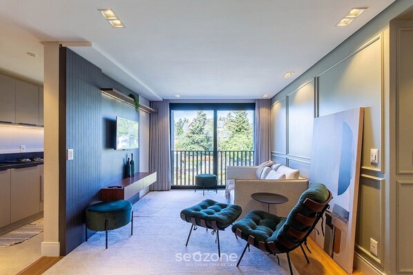 A modern interior with a kitchen, dining area, and seating space. - Apartment With Private Area and Balcony Mlub0301 (Gramado)