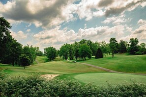 A golf course with a clear sky, trees, and a well-maintained green. - 3BR/2BA Barboursville, Near Mall, Parks, Marshall (Huntington)
