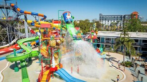 A water park with multiple slides and water features, surrounded by buildings and palm trees. - Coco Key Hotel 2 Double Studio Water Park Arcade (Orlando)
