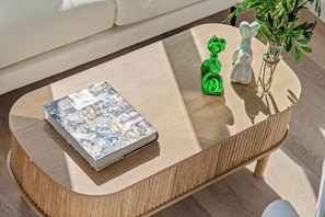 A wooden coffee table with a book and decorative items.