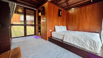 A room with a bed, a desk, and a window.