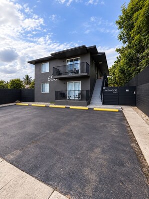 A modern two-story building with a flat roof, numbered 655, featuring balconies and a gated entrance. - 2BR Near Wynwood | Heated Pool + Private Balcony (Miami)
