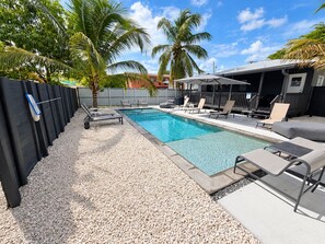 Private tropical pool with loungers, palms, and resort-style outdoor seating - 2BR Near Wynwood | Heated Pool + Private Balcony (Miami)