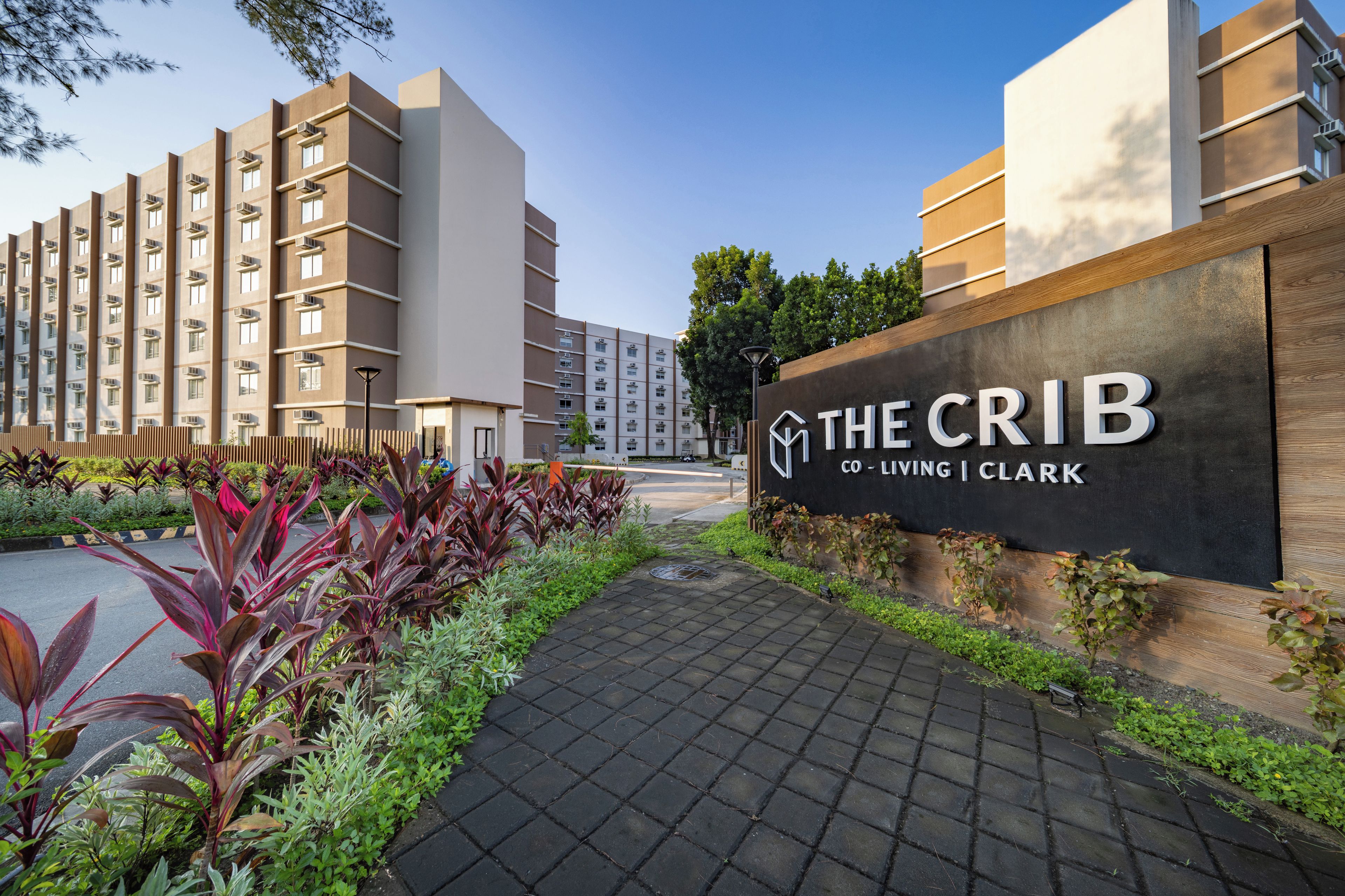 A residential building with a sign reading 'THE CRIB CO-LIVING CLARK'.