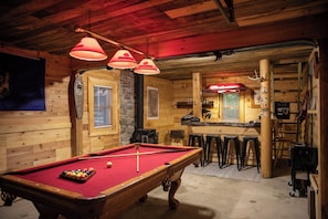 A pool table with balls, a bar area with stools, and a wooden interior. - Farmhouse Escape w/Hot Tub, EV Charger, Ski Bar - 10 mins to Sunday River (Rumford)
