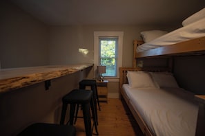 A compact room with bunk beds, a small desk, and a window. - Farmhouse Escape w/Hot Tub, EV Charger, Ski Bar - 10 mins to Sunday River (Rumford)