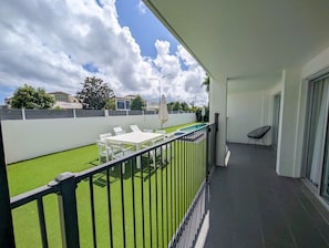 A balcony with a pool, outdoor furniture, and a view of the neighborhood. - Sunseeker Studio - Ground Floor Apt (Noosa Heads)