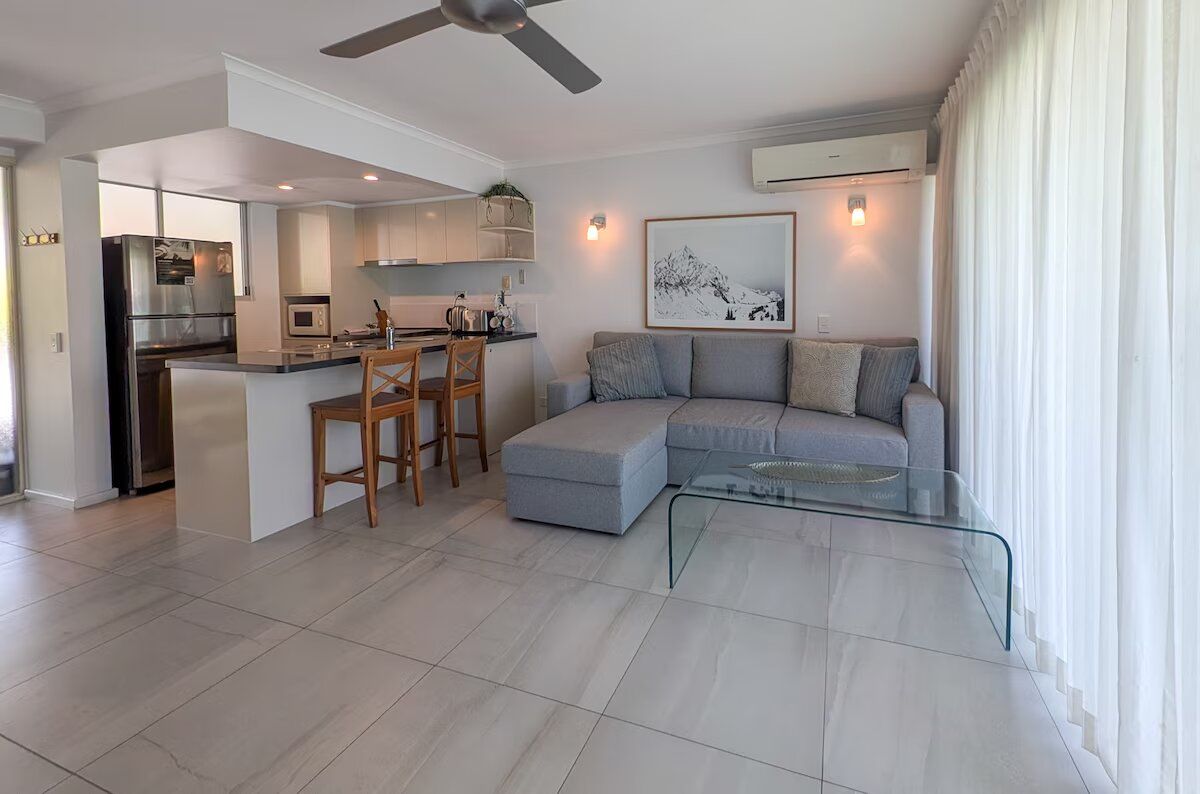 A modern living space with a kitchen, dining area, and seating area.