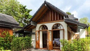 A traditional-style building with a sloped roof, wooden beams, and arched windows. - Siritarar Residence by Elite Havens (Lipa Noi)