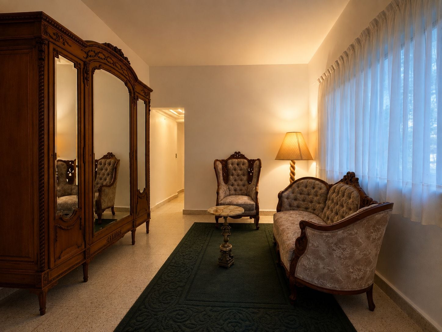 A room with a large mirror, two armchairs, a sofa, a lamp, and a patterned rug.