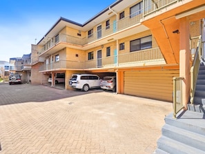A multi-story residential building with a garage and a staircase. - Palm Beach - Beachfront 3 Bedroom! (Palm Beach)
