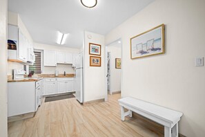 A modern kitchen with white cabinets, a built-in oven, and a granite countertop. - Kaanapali Maui Eldorado D103 Garden View 2 BD (Lahaina)