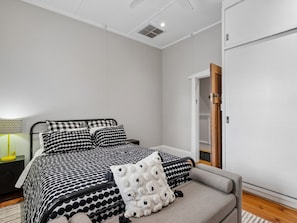A bedroom with a bed, bedside table, lamp, and a wardrobe. - The Calton Bungalow | 3br Heritage Stay in Gawler East (Gawler East)