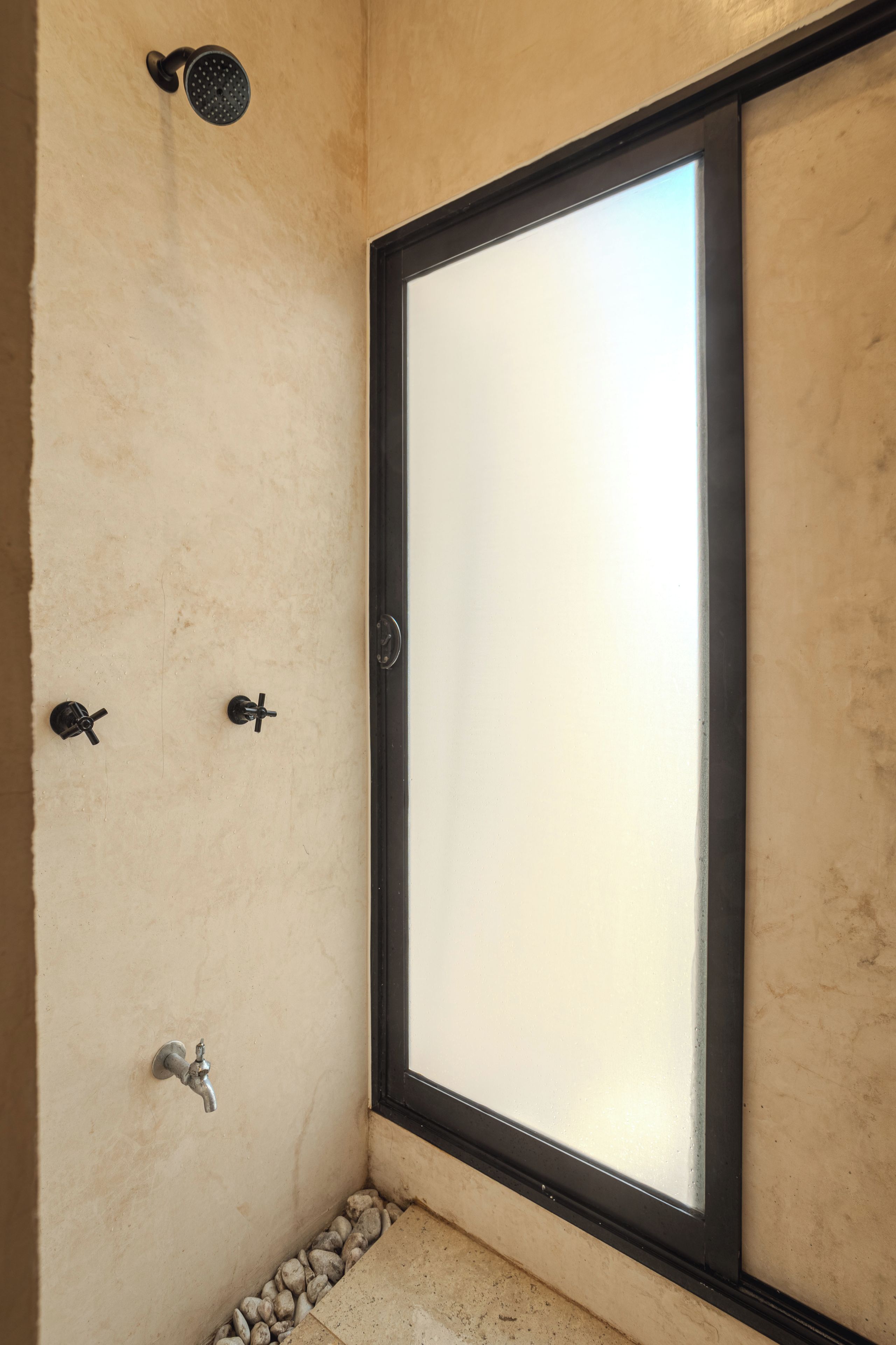 A bathroom with a shower, a toilet, and a sink.