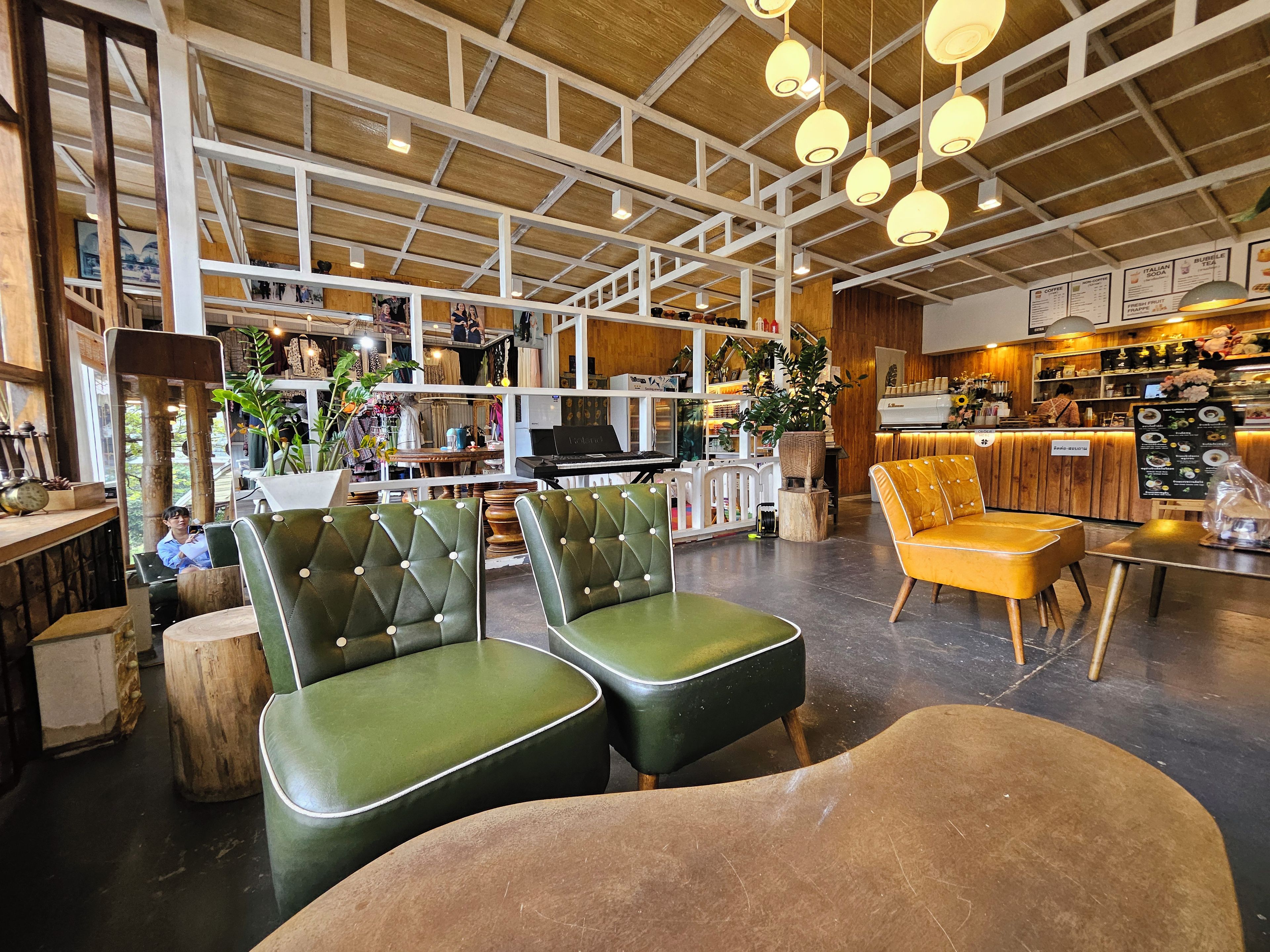 A modern interior with seating areas, a counter, and various plants.