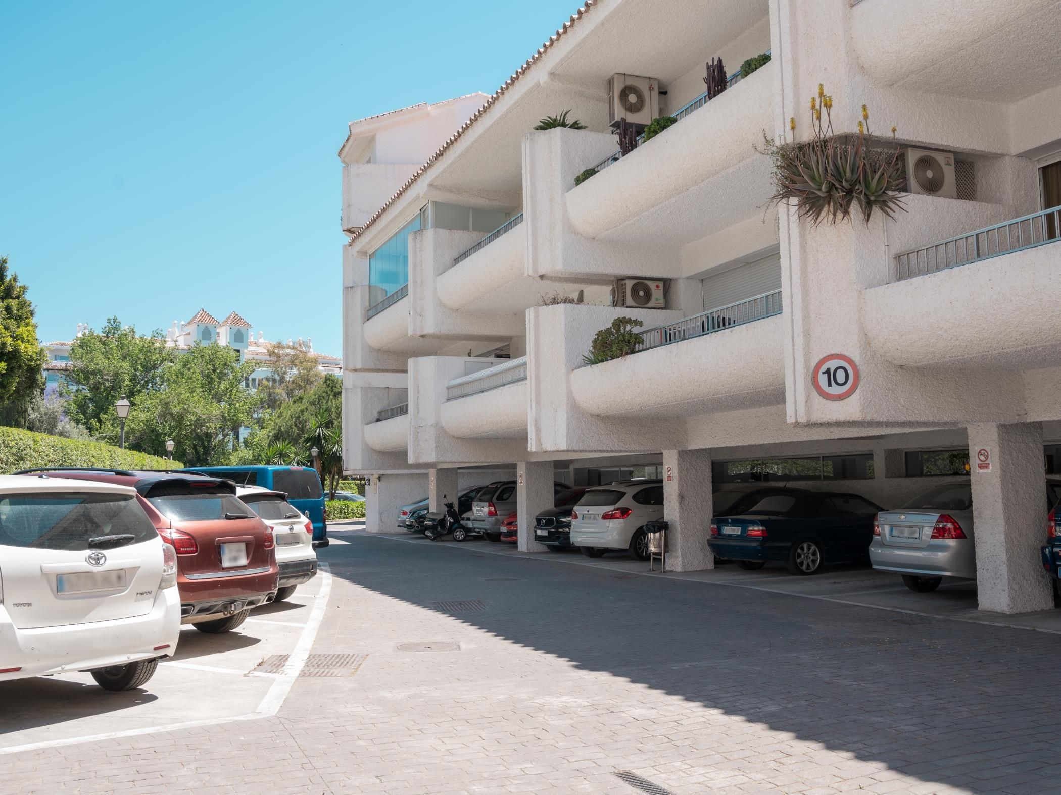 A multi-story parking garage with several cars parked.