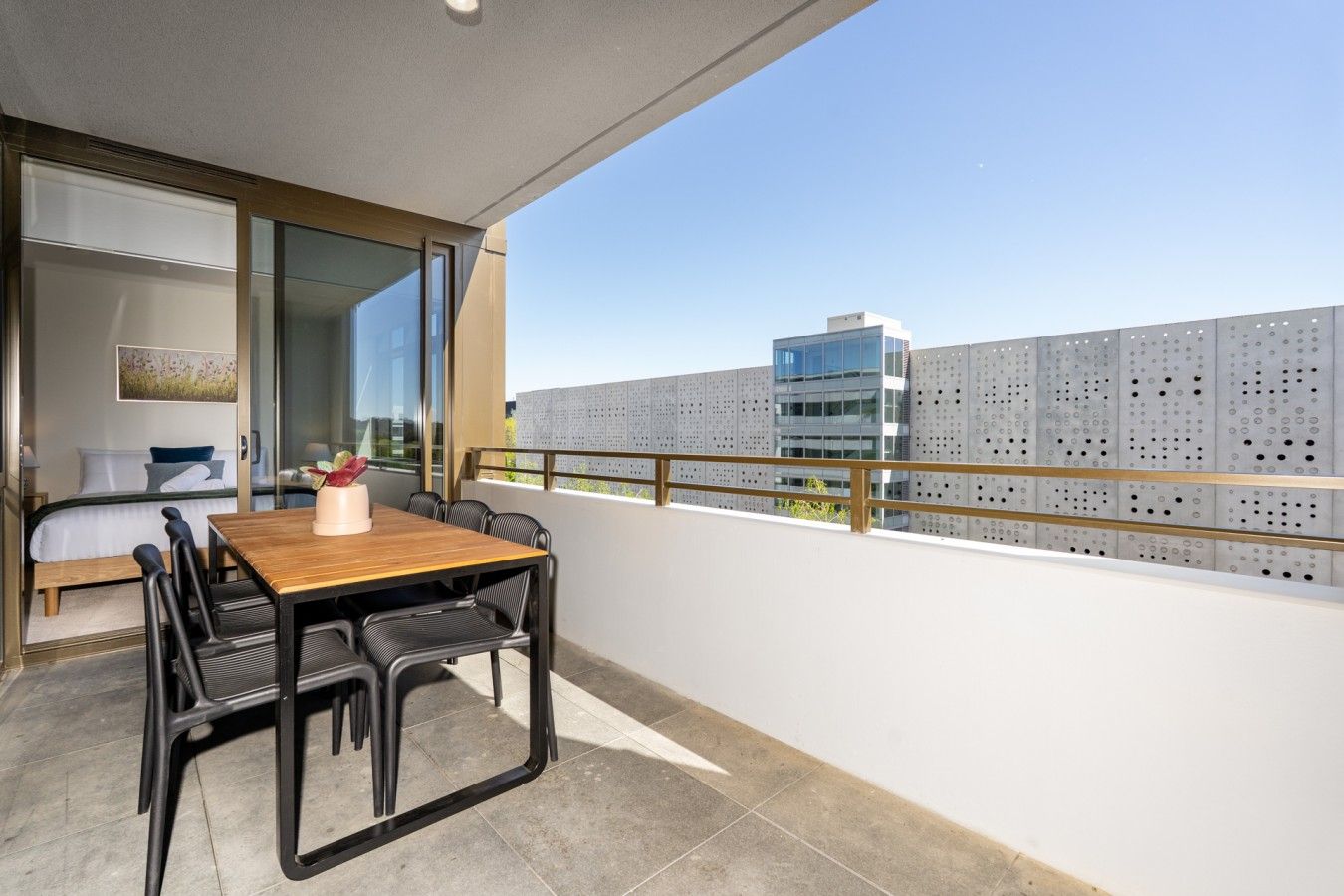 Step outside to the private balcony, furnished with outdoor seating and a table — a lovely spot to enjoy your morning coffee or unwind in the fresh air.