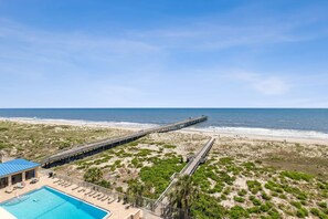 A beachside resort with a long pier, a swimming pool, and a beach area. - Comfy Upper Unit Condo To Enjoy The Beach Or The Fishing 2 Bedroom Condo (Fernandina Beach)