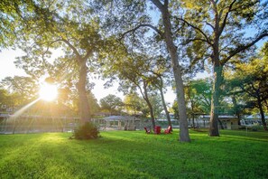 A park with trees, grass, and a body of water. - Fish Haus-Seguin Texas (Seguin)