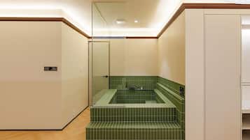 A bathroom with a bathtub, a shower, and a toilet.
