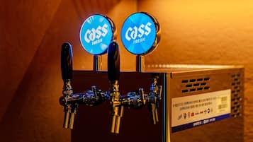 A tap with two blue labels reading 'Cass Fresh' and a metal box with text and logos.