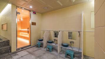 A public restroom with wooden benches, individual sinks, and a tiled floor.