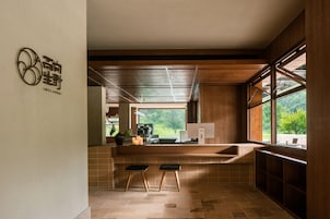 A modern kitchen with a large window, a built-in stove, and a sink.