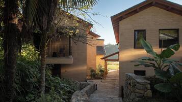 A modern building with a stone pathway leading to a wooden door.