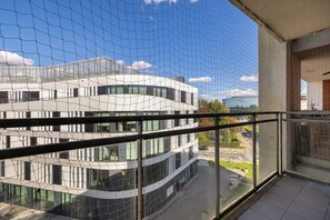 A modern building with a glass facade and multiple windows. - Cracow | Dworska 1B | Functional Apartment | Balcony (Kraków)