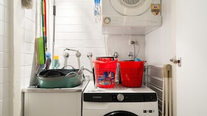 A compact washer and dryer unit with a front-loading washing machine, a drying machine, and a wall-mounted exhaust fan. - Myrtle House Loft - City Views & Amazing Rooftop (Chippendale)