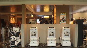 A public restroom with three urinals, a panda-themed decoration, and a poster on the wall.
