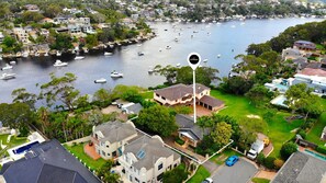A residential area with houses, a marina, and boats.