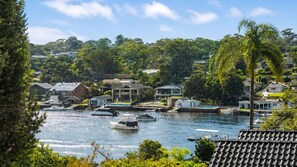 A coastal residential area with houses, a marina, and boats.