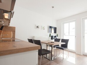 A modern kitchen with a wooden countertop and stainless steel appliances. - Seilerstr./knyphausenstr.26a - Nele (Norderney)