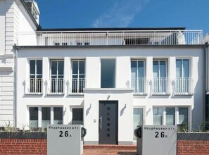A two-story building with a flat facade, numbered 26A and 26B, featuring a central entrance and balconies. - Seilerstr./knyphausenstr.26a - Nele (Norderney)