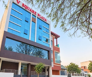 A modern building with a sign reading 'V SQUARE PLAZA'. - Classic Hotel Crystal Grand (Kanpur)