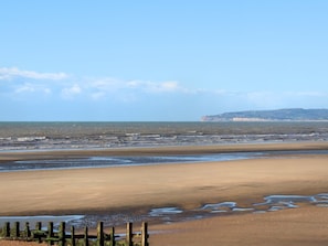 A wide beach with a fence in the foreground and a distant landmass. - Mkrj Luxury Sleeps 4 - Pet Friendly - (Rye)