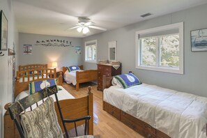A bedroom with two single beds, a wooden chair, a dresser, and a ceiling fan. - 13-Acre Vermont Estate w/ Hot Tub & Game Room (West Dover)