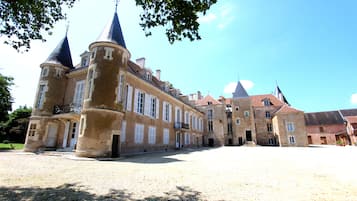 A historic building with multiple towers and a courtyard.