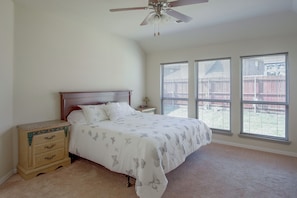 A bedroom with a bed, nightstand, dresser, and a ceiling fan. - Lewisville Lake Escape, 4 Mi to Boat Ramp (Little Elm)