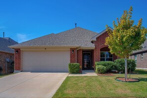 A single-story brick house with a garage, a front lawn, and a tree. - Lewisville Lake Escape, 4 Mi to Boat Ramp (Little Elm)