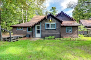 A rustic wooden cabin with a front porch, a single door, and a small window. - Adirondack Cabin at Historic Fenton House Hotel (Lowville)