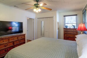 A bedroom with a bed, a dresser, a television, a ceiling fan, and a window with blinds. - 2 Mi to Dtwn Pensacola: Historic Home w/ Patio! (Pensacola)