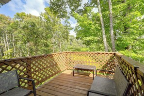 A wooden deck with a lattice railing, a bench, and chairs. - 3 Blocks to the Slopes! Sugar Mtn Ski Condo (Sugar Mountain)