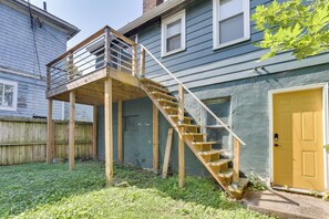 A wooden deck with a staircase leading to a balcony, a door, and a fenced yard. - Nurse-Ready Rental 1 Mi to Franciscan University! (Steubenville)