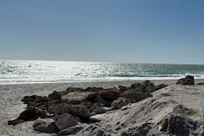 A rocky beach with waves crashing onto the shore. - Luxury Bayfront Home, Private Dock, Steps to Beach (Englewood)