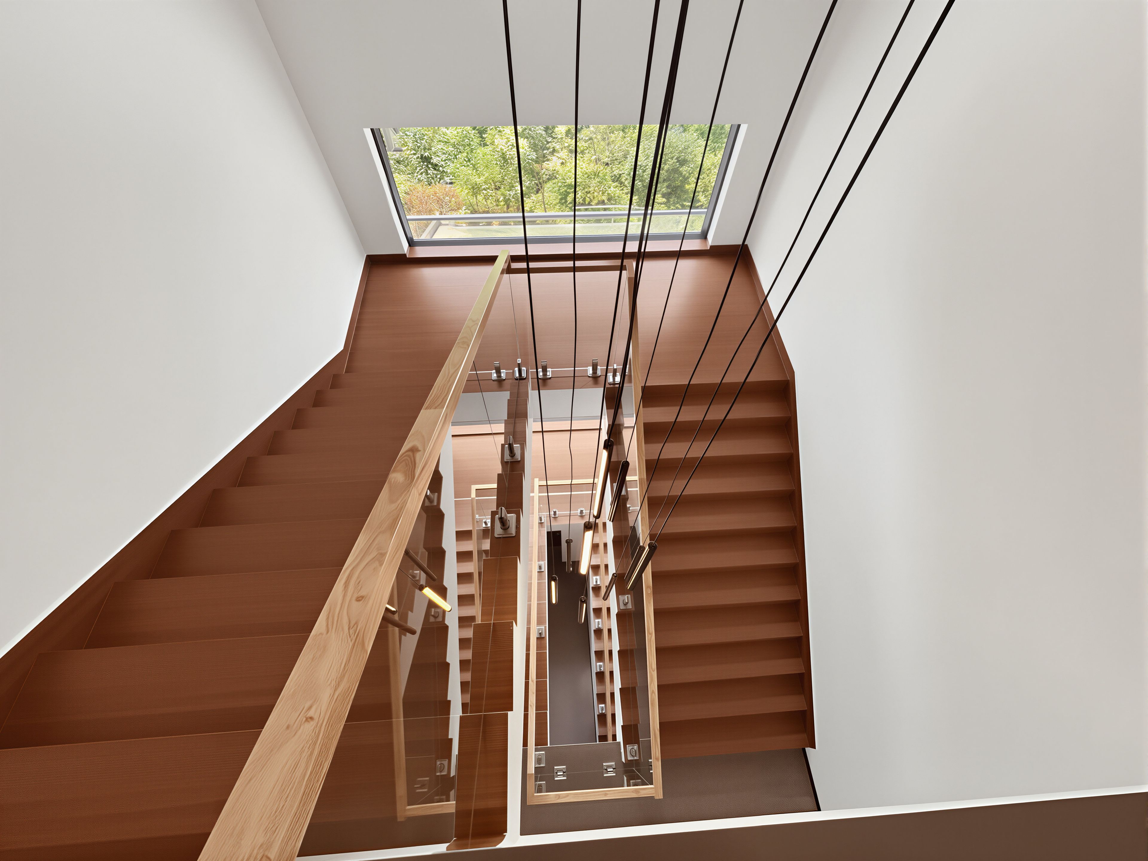 A modern interior with a wooden staircase leading to a skylight.